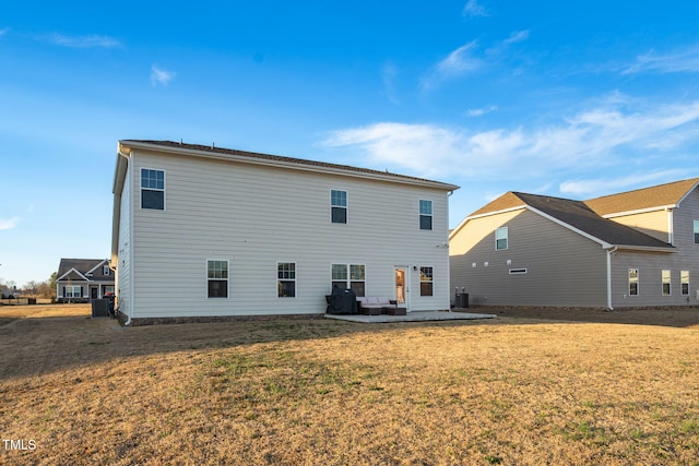 back of house with a patio area and a yard