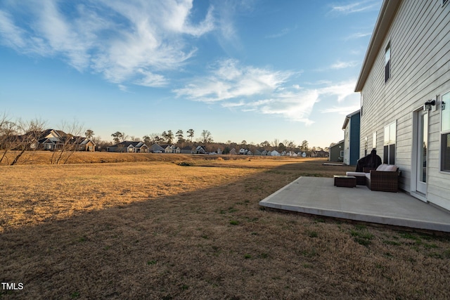 view of yard featuring a patio area and a residential view