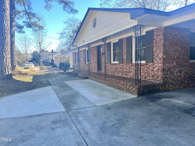 view of side of property featuring brick siding