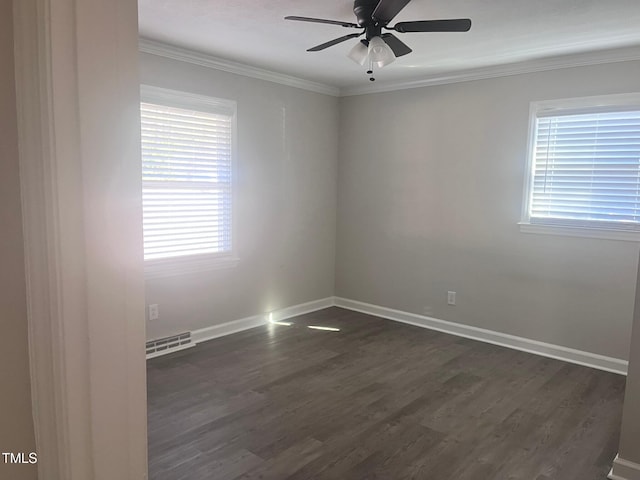 empty room featuring a ceiling fan, visible vents, baseboards, ornamental molding, and dark wood-style floors