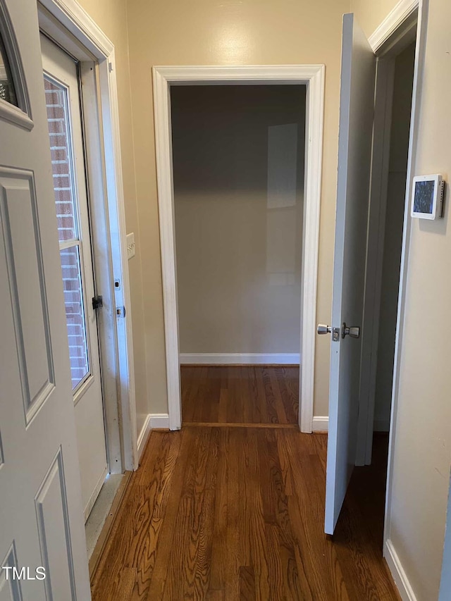 hall with wood finished floors and baseboards