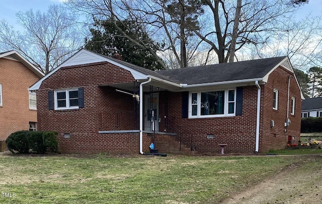 view of front of house with brick siding, crawl space, and a front yard