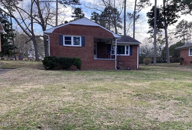 view of front facade with a front yard and brick siding