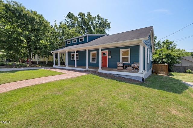 view of front of house featuring a porch, fence, and a front yard