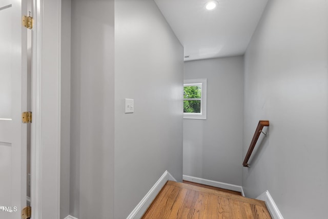 staircase with baseboards, recessed lighting, and wood finished floors