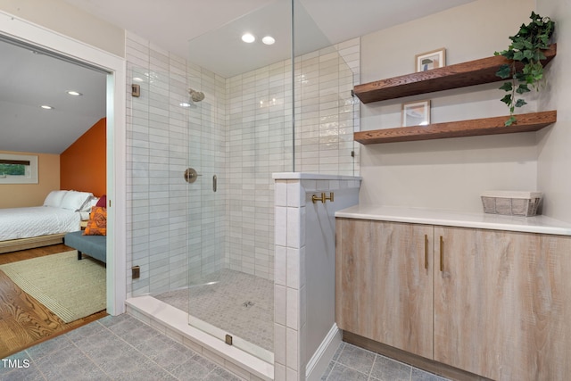 ensuite bathroom featuring recessed lighting, ensuite bath, and a tile shower