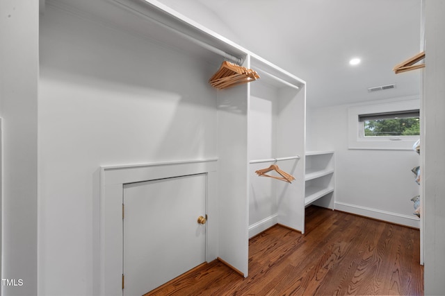 walk in closet with visible vents and wood finished floors