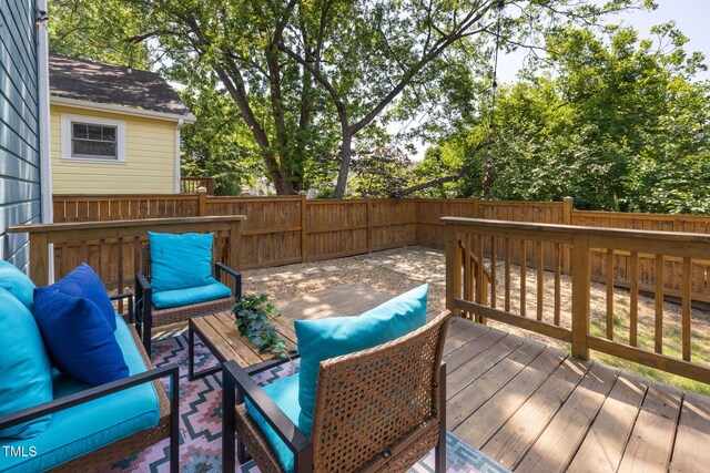 wooden terrace featuring outdoor lounge area and a fenced backyard