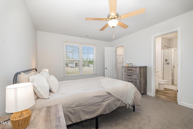 bedroom featuring visible vents, baseboards, ensuite bath, ceiling fan, and carpet floors