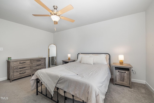 bedroom with baseboards, a ceiling fan, and light colored carpet