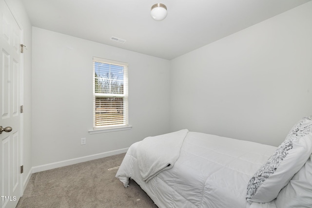 carpeted bedroom with visible vents and baseboards