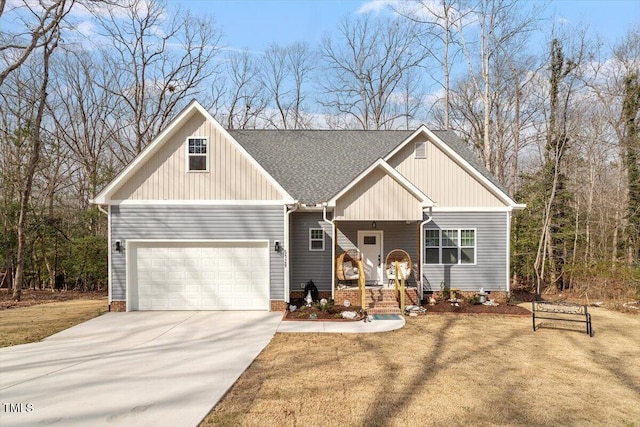 craftsman inspired home featuring concrete driveway, roof with shingles, an attached garage, covered porch, and a front yard