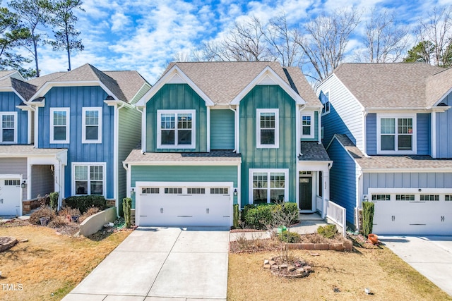 view of front of house with board and batten siding, a garage, driveway, and a shingled roof