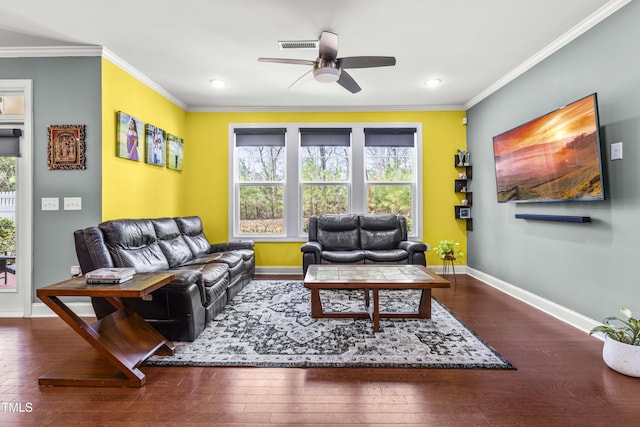 living area with wood-type flooring, crown molding, baseboards, and ceiling fan