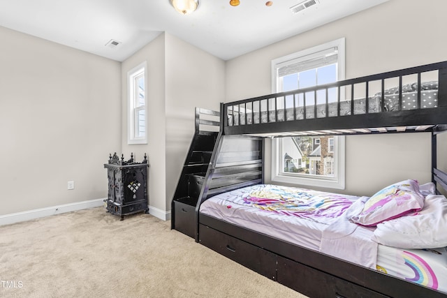 bedroom with multiple windows, visible vents, and carpet flooring