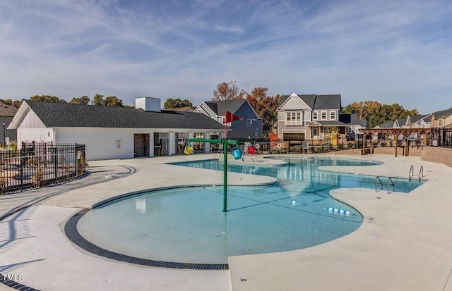 pool featuring a patio area and fence