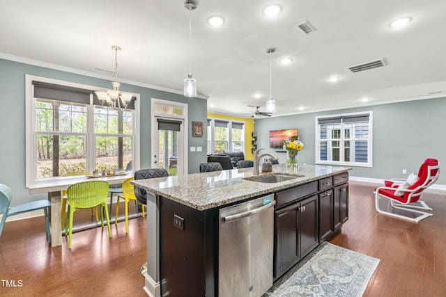 kitchen featuring visible vents, dishwasher, dark wood-type flooring, crown molding, and a sink