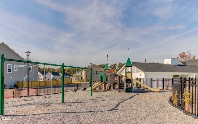 community play area with fence and a residential view