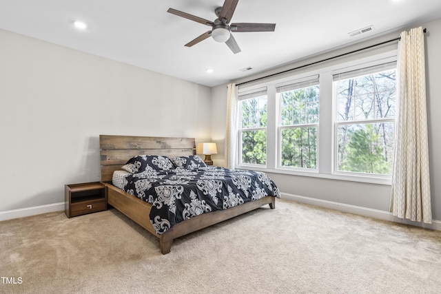 carpeted bedroom with multiple windows, recessed lighting, a ceiling fan, and baseboards