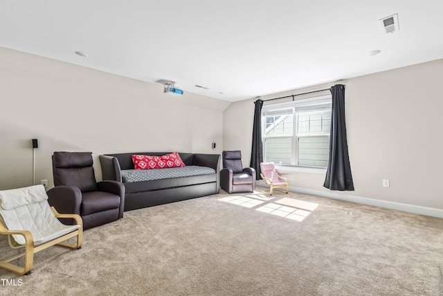 interior space featuring lofted ceiling, carpet, visible vents, and baseboards