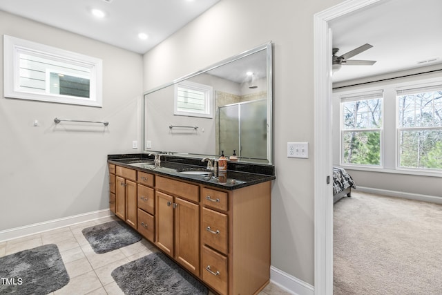 full bathroom featuring double vanity, tile patterned flooring, a sink, and a shower stall