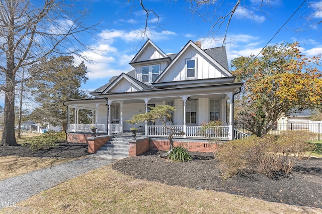 view of front facade featuring a chimney, roof with shingles, fence, a porch, and board and batten siding