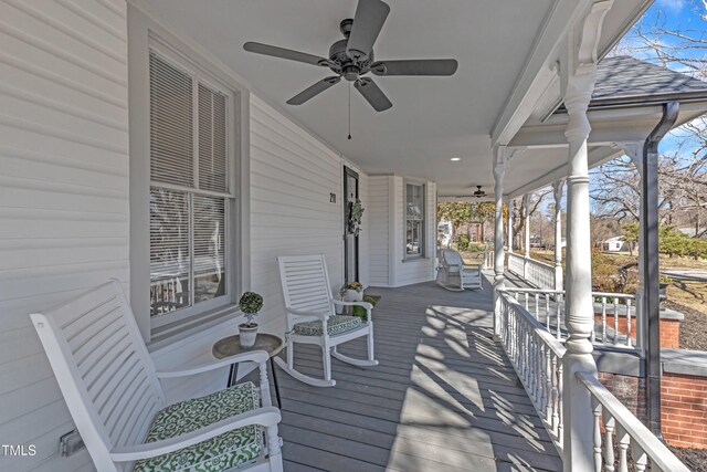 deck with a ceiling fan and covered porch