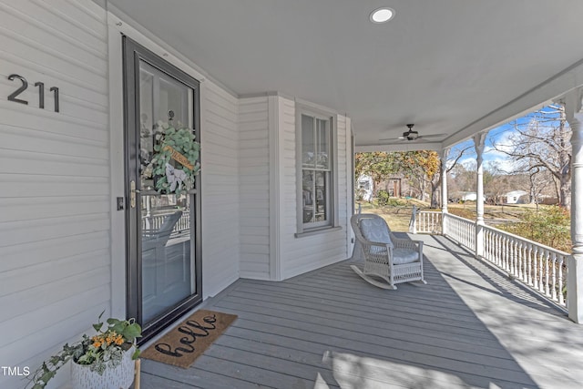 wooden terrace with a porch and ceiling fan