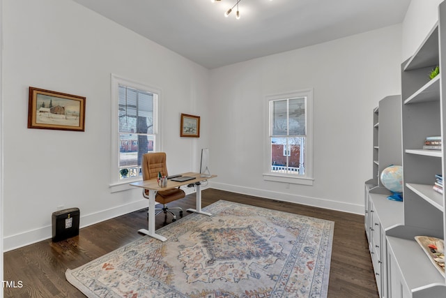 office with dark wood-style floors and baseboards