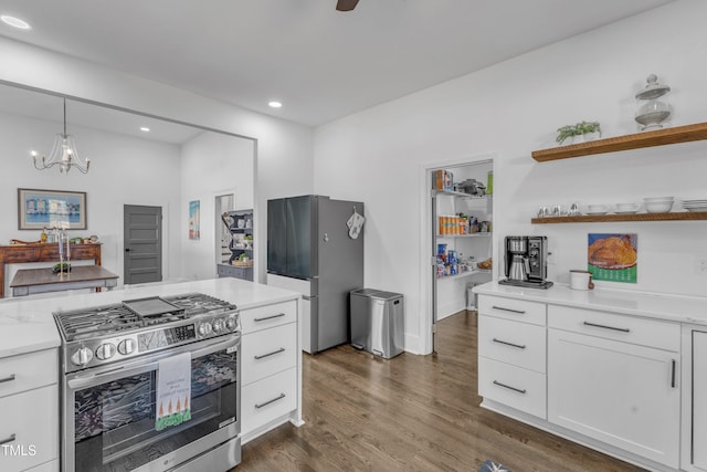 kitchen featuring decorative light fixtures, open shelves, appliances with stainless steel finishes, dark wood-type flooring, and white cabinetry