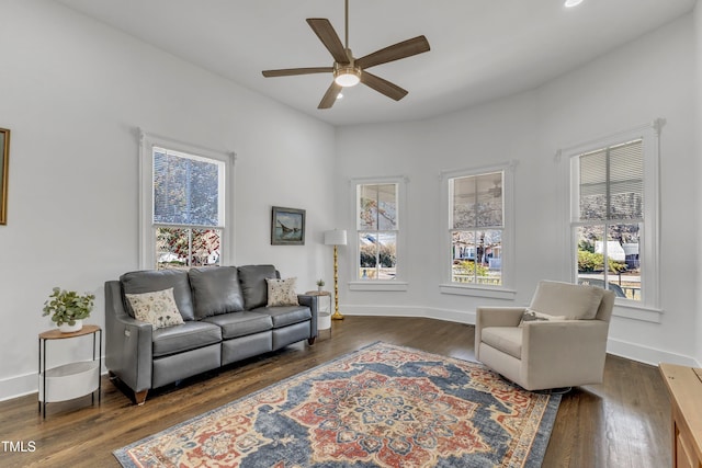 sitting room with dark wood finished floors and baseboards