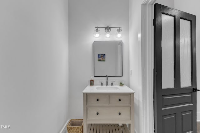 bathroom with baseboards and vanity