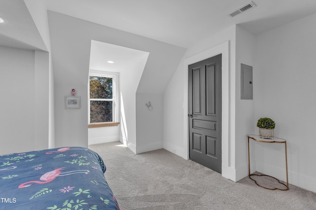 carpeted bedroom featuring lofted ceiling, baseboards, electric panel, and visible vents