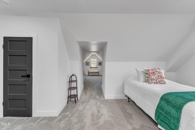 bedroom with lofted ceiling, carpet flooring, and baseboards