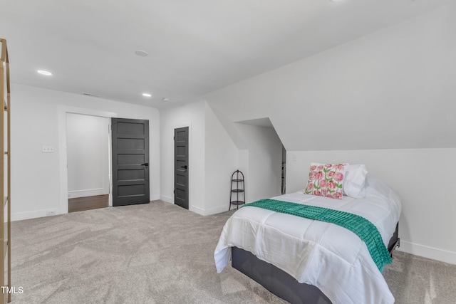 bedroom with carpet floors, recessed lighting, vaulted ceiling, and baseboards