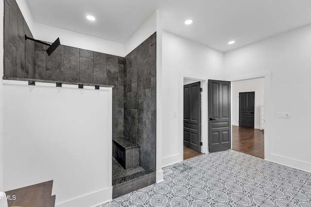 bathroom with tile patterned floors, baseboards, walk in shower, and recessed lighting