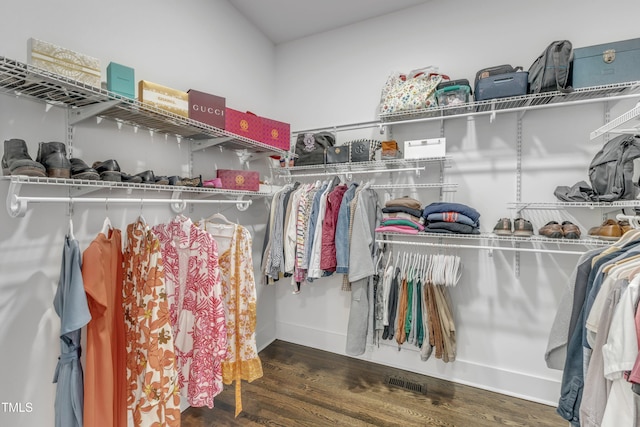 walk in closet with visible vents and wood finished floors