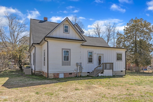 back of property featuring roof with shingles, a yard, a chimney, crawl space, and fence