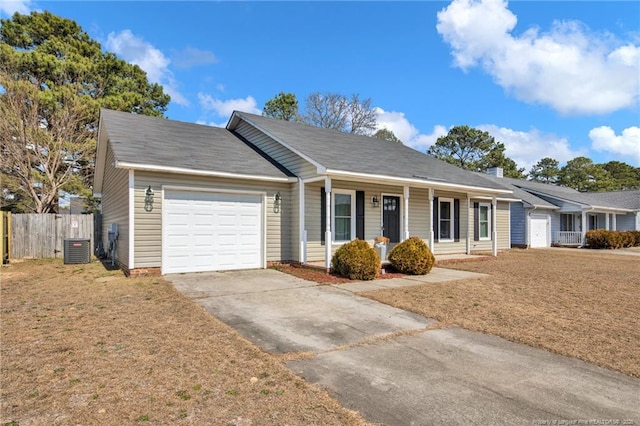 ranch-style home with an attached garage, driveway, fence, and central AC unit