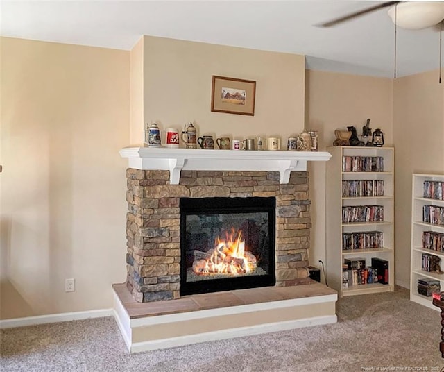 room details with a ceiling fan, carpet, a fireplace, and baseboards