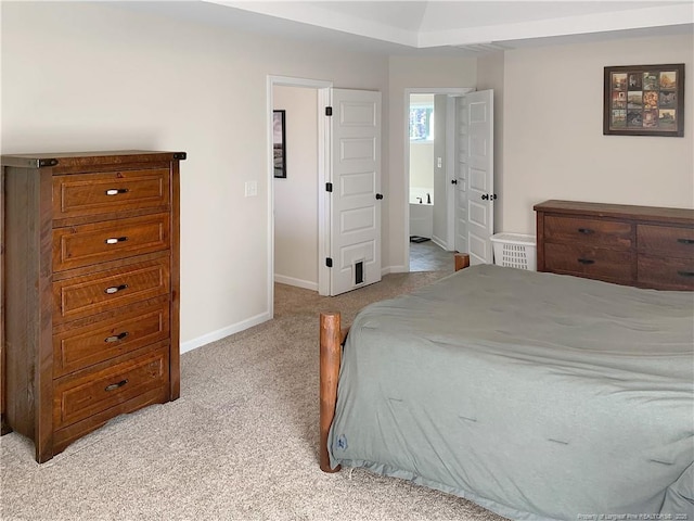 bedroom with light colored carpet and baseboards