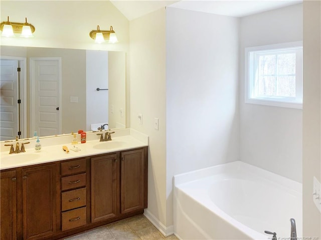 full bathroom with double vanity, a sink, a bath, and tile patterned floors