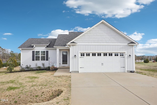 view of front of home featuring board and batten siding, concrete driveway, roof with shingles, and an attached garage