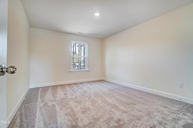 carpeted spare room with visible vents, baseboards, and recessed lighting