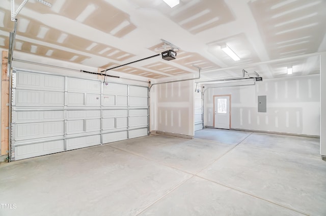 garage with a garage door opener and electric panel