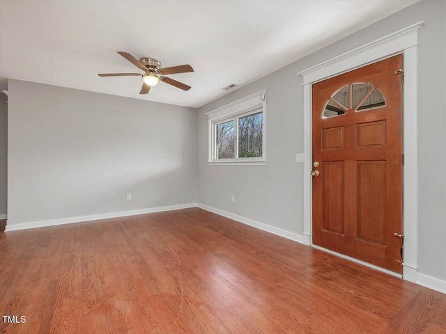 entrance foyer featuring ceiling fan, wood finished floors, visible vents, and baseboards