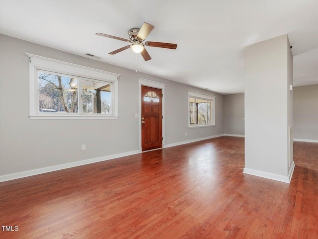 foyer with ceiling fan, wood finished floors, visible vents, and baseboards