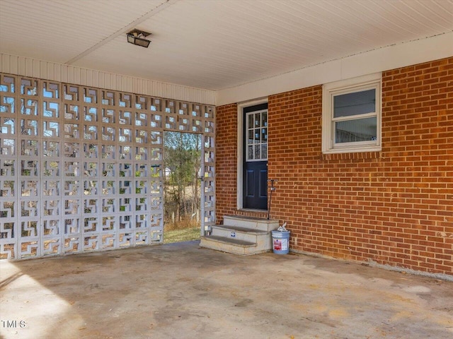 property entrance featuring brick siding