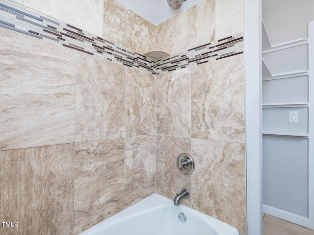 interior details featuring shower / bath combination