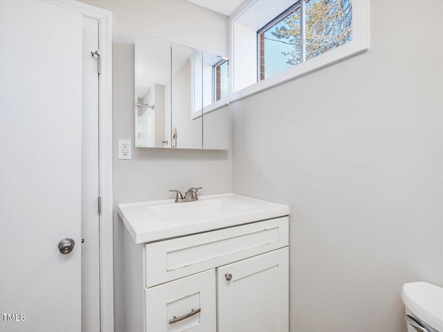 bathroom featuring toilet and vanity